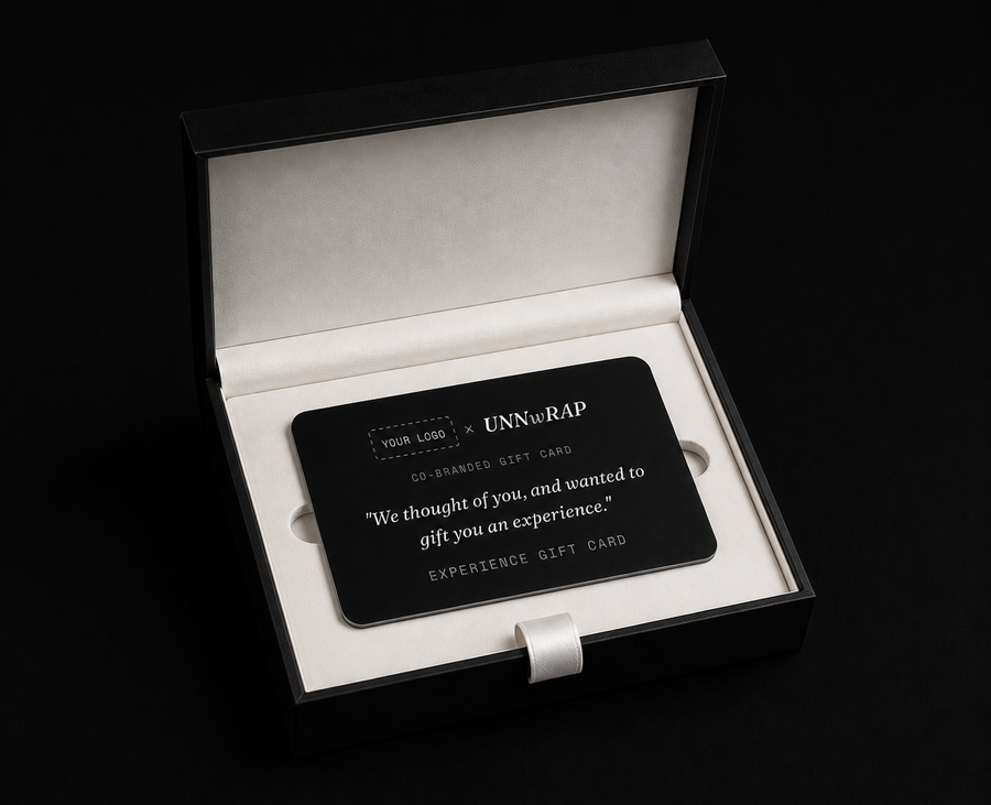 Unnwrap experience gift card inside an open black gift box